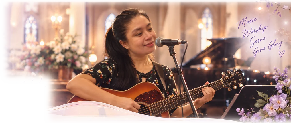 Florane singing into a microphone and playing an acoustic guitar inside a candlelit church