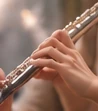 Silver flute being played, keys in close-up